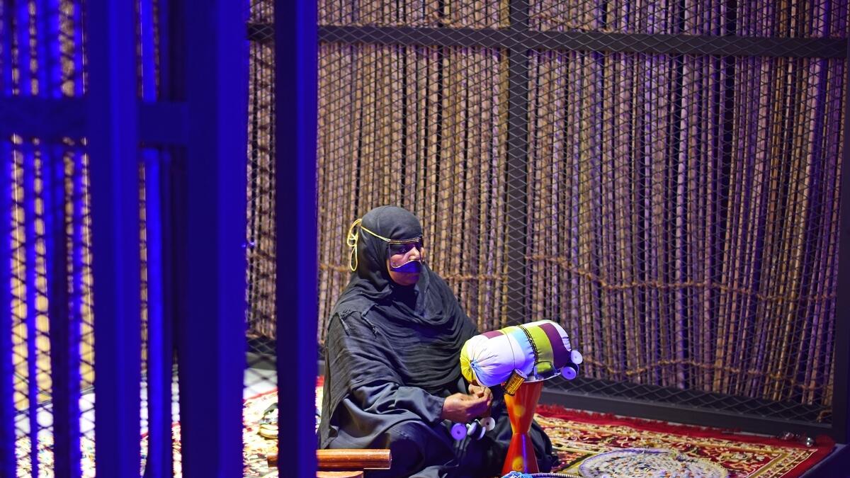 Emirati woman demonstrates traditional weaving skills at a heritage site during the Al Shindagha Days festival in Dubai.
