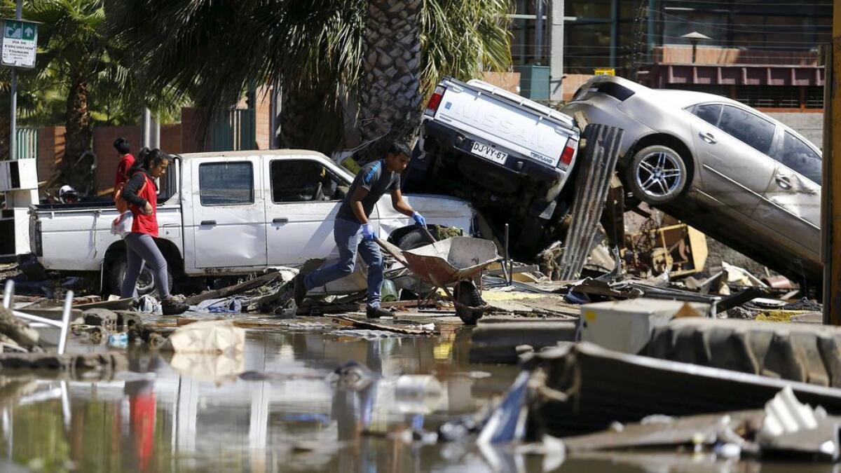 Damaged cars lie on debris after an earthquake hit areas of central Chile, in Coquimbo city, north of Santiago, Chile. 