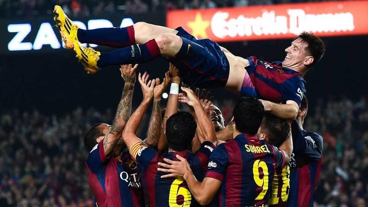 Messi is hoisted into the air by his Barcelona team-mates after the Argentine broke the record for most goals in the Spanish league