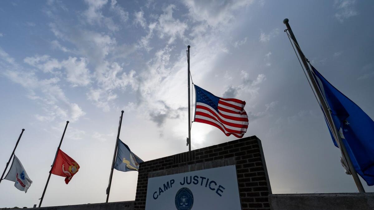 Flags fly at half-staff at Camp Justice on August 29, 2021, in Guantanamo Bay Naval Base, Cuba. — AP file