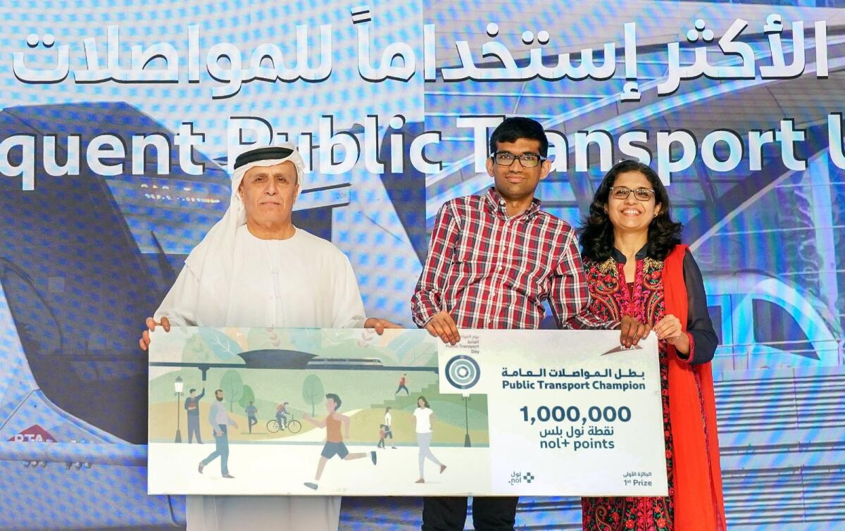 Dhiren Bhatia (centre), who topped the list with 8,000 journeys in the people of determination category, receives the award from Mattar Al Tayer, RTA director general and chairman of the board of executive directors (left). — Supplied photos