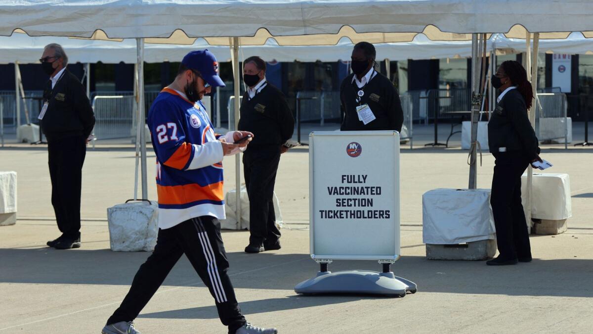 Fans arrive to directions to the vaccinated or unvaccinated sections prior to a Stanley Cup Playoffs game in New York. Photo: AFP