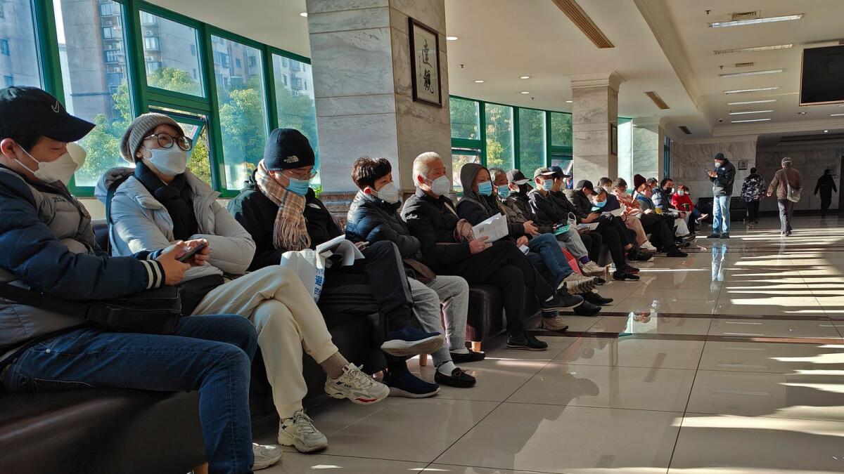 Family members of the deceased wait for the cremation procedures at a funeral home in Shanghai, China. — AP