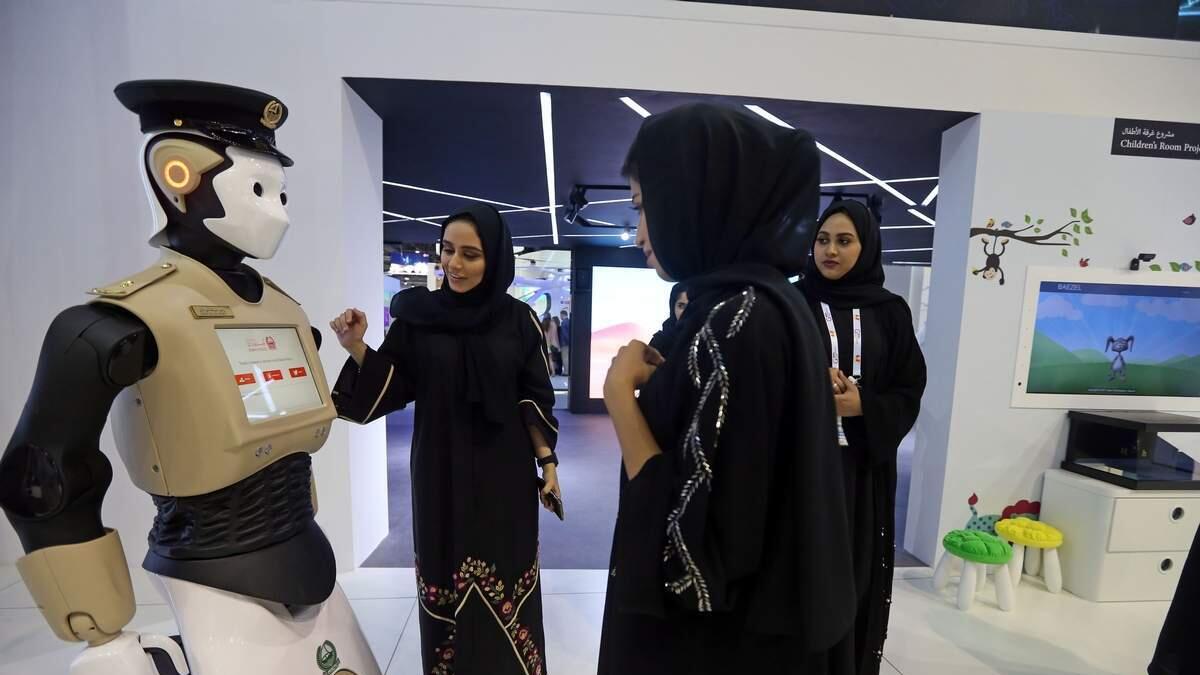 Visitors interact with the Dubai Police Robot at Gitex Technology Week.- Photo by Dhes Handumon