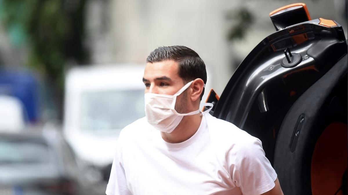 AC Milan's Theo Hernandez is seen wearing a protective face mask as he arrives at Hospital Clinica La Madonnina in Milan for general medical tests on Tuesday. - Reuters
