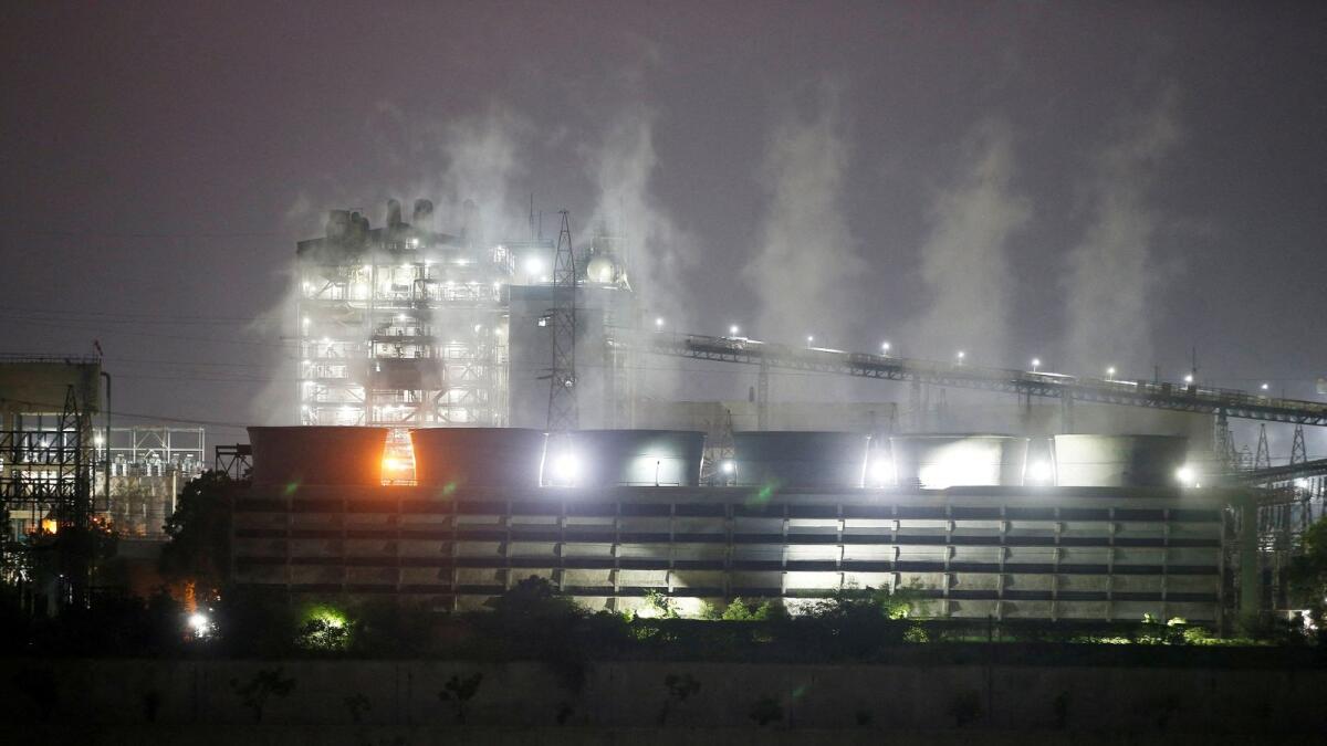 Smoke billows from the cooling towers of a coal-fired power plant in Ahmedabad, India. — Reuters file