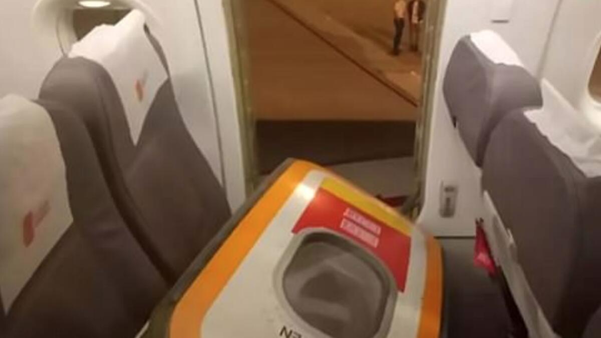 Photos: Passenger opens plane door for fresh air 