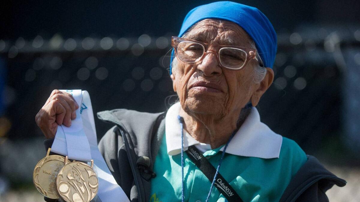 Vancouver : Man Kaur, 100, of India, holds the gold medals she won in shot put and javelin events before competing in the 100-meter track and field event at the Americas Masters Games in Vancouver, British Columbia, Monday, Aug. 29, 2016. More than 10,000 athletes aged 30 and older are participating in the games which continue until Sept. 4. AP/PTI(AP8_30_2016_000019B)