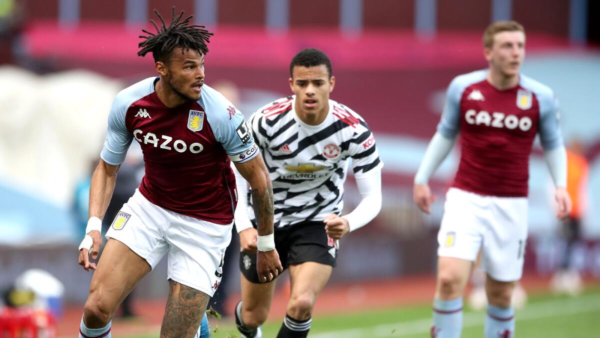 Aston Villa's Tyrone Mings (left) controls the ball during the English Premier League soccer match against Manchester United. — AP