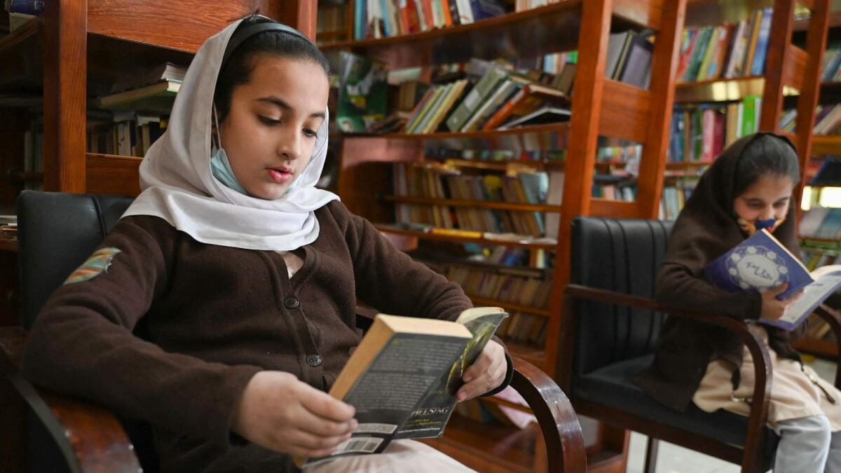School students read books inside the Darra Adam Khel Library in Darra Adamkhel town, some 35 kilometres (20 miles) south of Peshawar.  — AFP