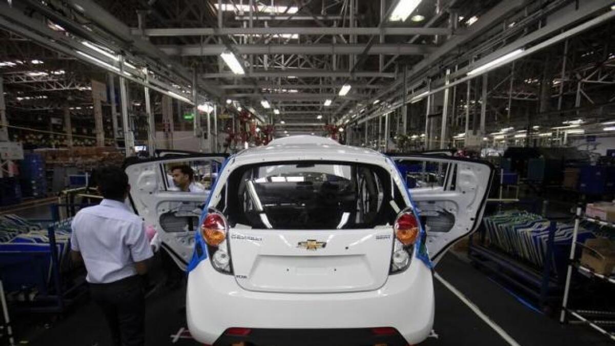 Employees work on a Chevrolet Beat car at a factory in India.  India's small and medium-sized auto-component industry workforce is estimated at about 5 million.