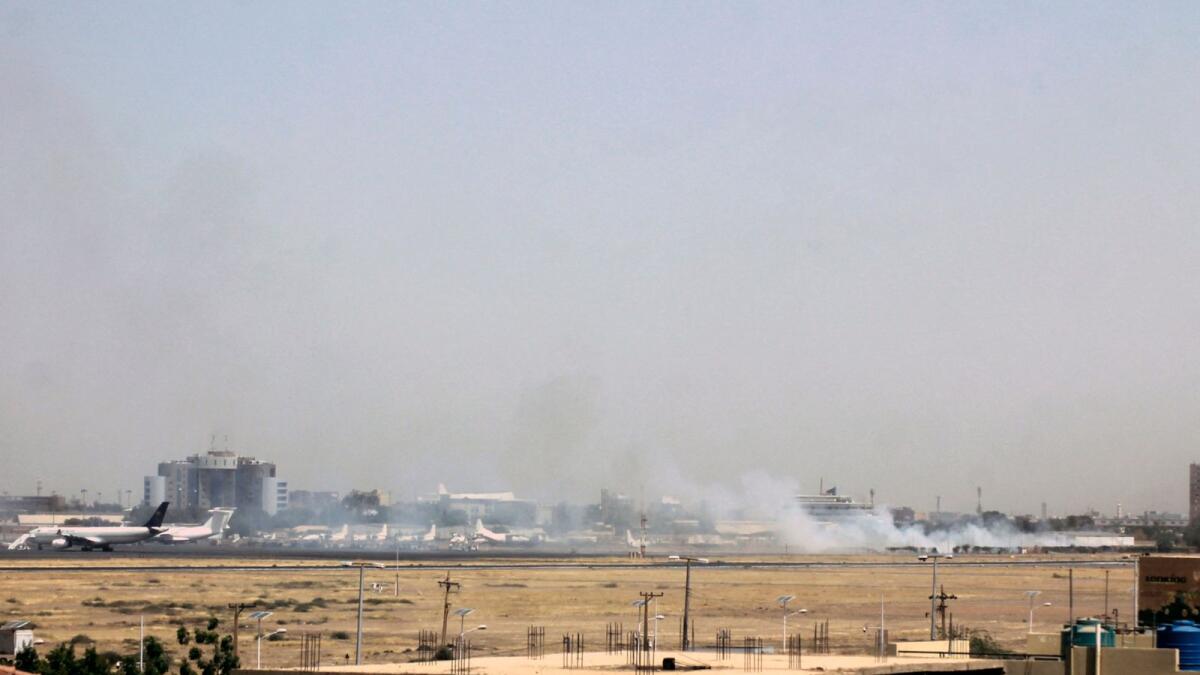 Smoke can be seen on the tarmac of the Khartoum airport on April 15, 2023, amid clashes in the Sudanese capital. — AFP