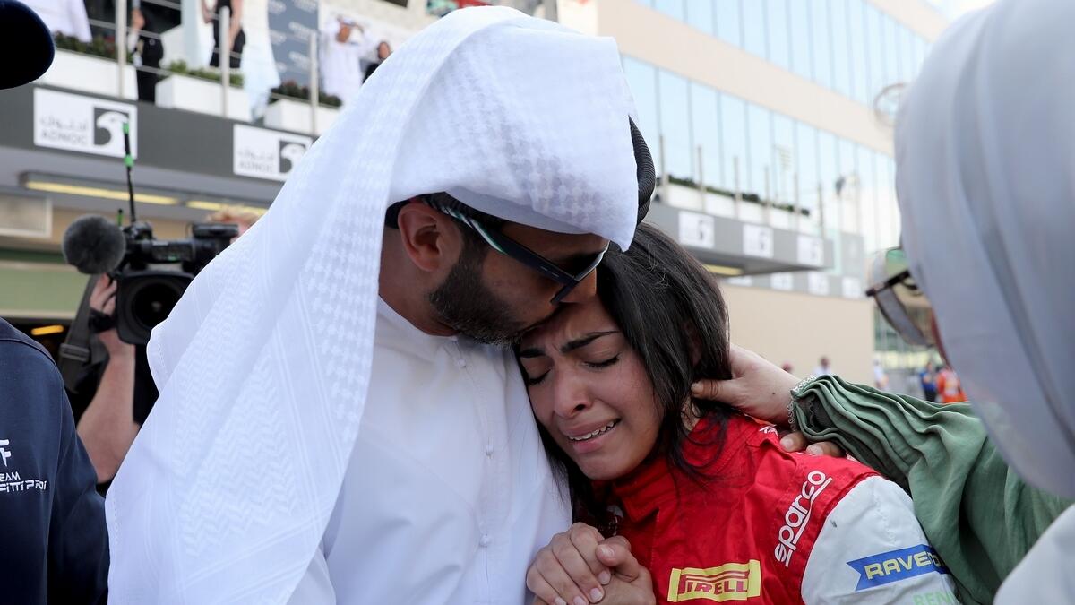 Emirati driver Amna Al Qubaisi is comforted by her father Khaled Al Qubaisi after she won F4 UAE Trophy Round at Yas Marina Circuit.-Photo by Ryan Lim/Khaleej Times
