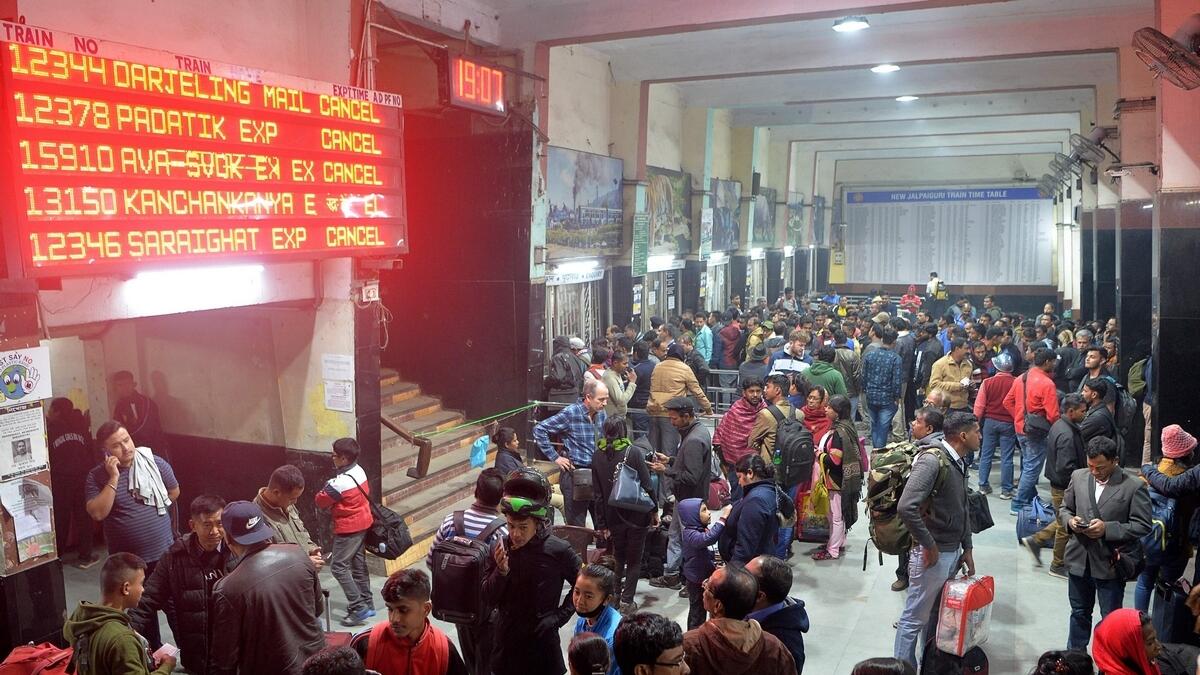 Commuters wait as trains has been cancelled at New Jalpaiguri Railway station on the outskirts of Siliguri following protest against the Indian government's Citizenship Amendment Bill (CAB). AFP