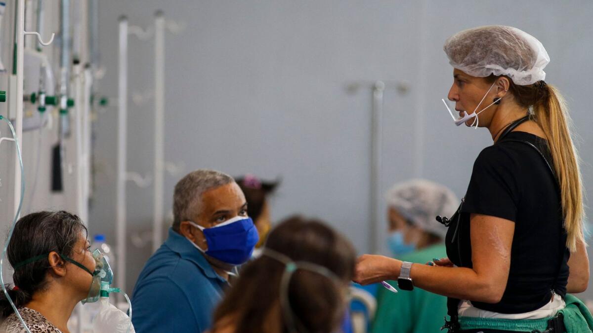 Brazilian surgeon Marise Gomes (R), 53, tends to patients at a hospital set up at a sports gym in Santo Andre, Sao Paulo State, Brazi.