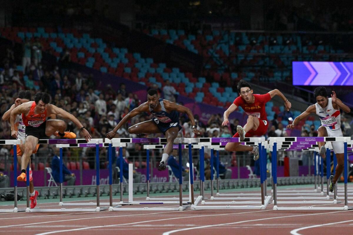 Kuwait's Yaqoub Al-Youha (centre) during the men's 110m hurdles final. — AFP