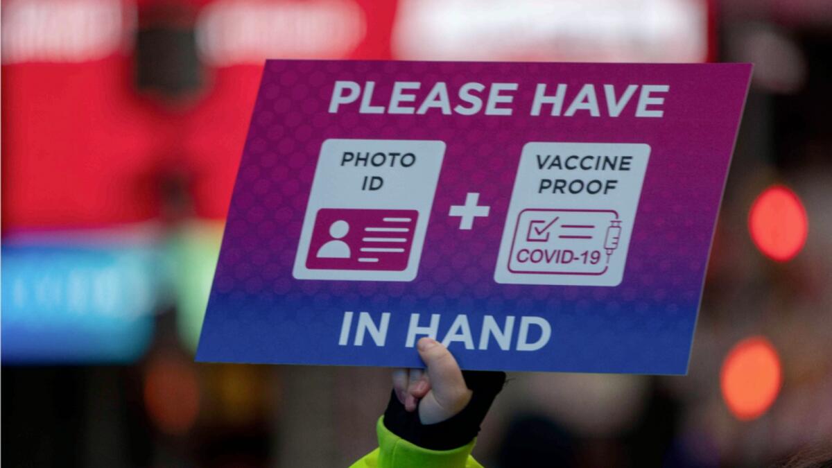 A person holds a sign at a check point as revellers gather ahead of New Year's Eve celebrations in Times Square. — AFP