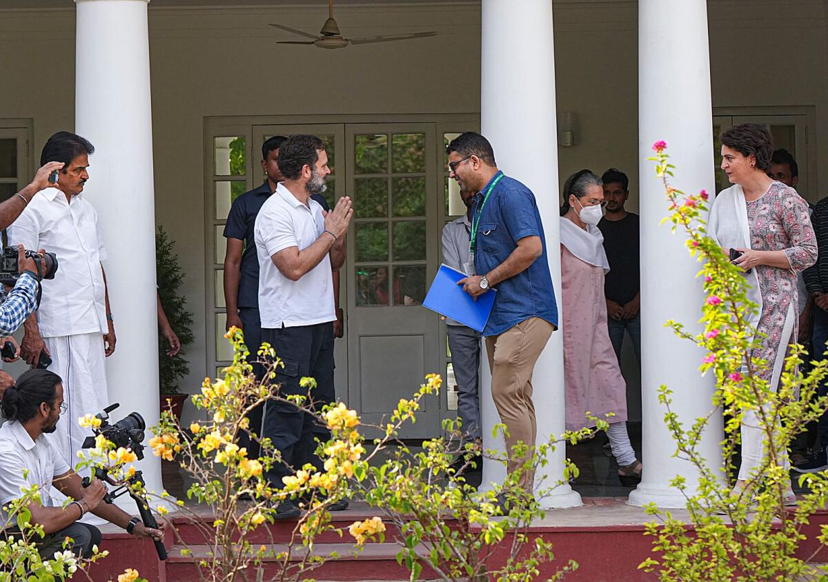 Congress leader Rahul Gandhi hands over the key of 12, Tughlak Lane bungalow as he vacates the bungalow after his disqualification as a Lok Sabha MP in New Delhi on Saturday, April 22, 2023. Congress leaders Sonia Gandhi, Priyanka Gandhi and K.C. Venugopal are also seen. — PTI