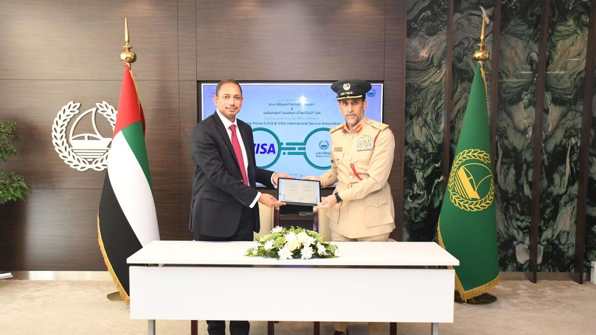 Lt-Gen Abdullah Khalifa Al Marri and Charles Lobo after signing the MoU to join the Operation Centre for Economic Crimes. — Wam
