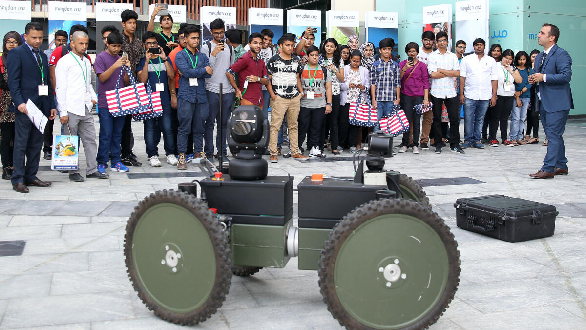 Visitors look at the remote controlled Introbot, an Independent four-wheel drive equipment. -Photo by Juidin Bernarrd/Khaleej Times