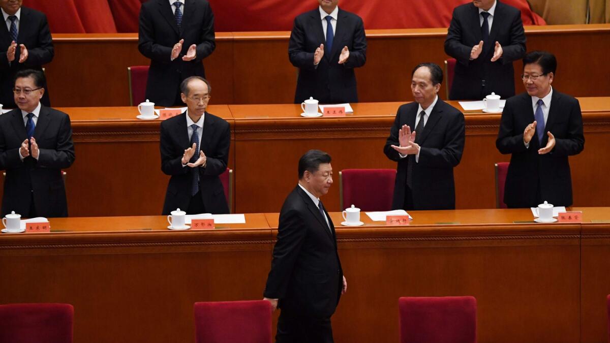 Chinese President Xi Jinping is applauded as he arrives for a ceremony marking the 70th anniversary of China's entry into the Korean War, in Beijing's Great Hall of the People on Friday.