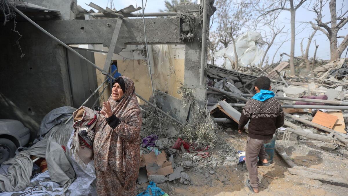 Palestinians inspect the site of an Israeli strike on a house in Khan Younis. — Reuters