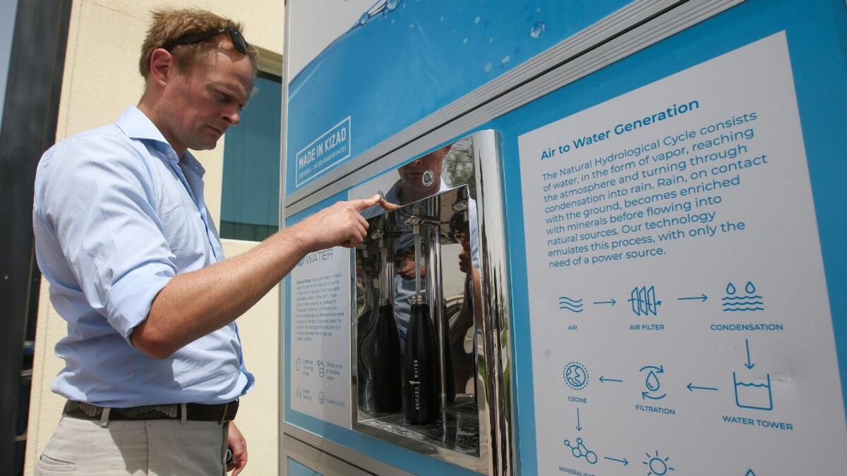 Ed Aitken, Eshara Water Global Operations Director, with the machine that produces drinking water from air. KT Photo: Ryan Lim
