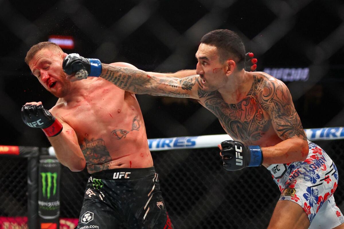 Max Holloway (right) punches Justin Gaethje during the UFC 300. — Reuters