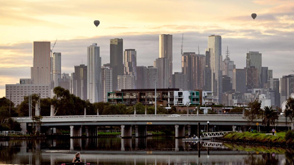 A rower makes their way along the Maribyrnong River towards the Melbourne skyline in the early morning light on April 18, 2023. — AFP file