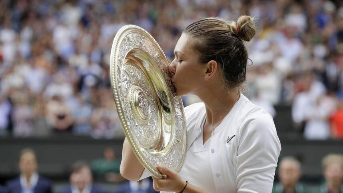 Simona Halep kisses the Wimbledon trophy after defeating Serena Williams in the final last year. - AP file