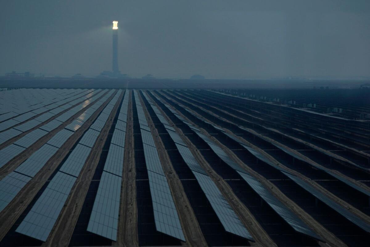 A solar tower and panels operate at the Mohammed bin Rashid Al Maktoum Solar Park as Dubai.  The world's renewable energy grew at its fastest rate in the past 25 years in 2023, the International Energy Agency reported on Thursday. — AP