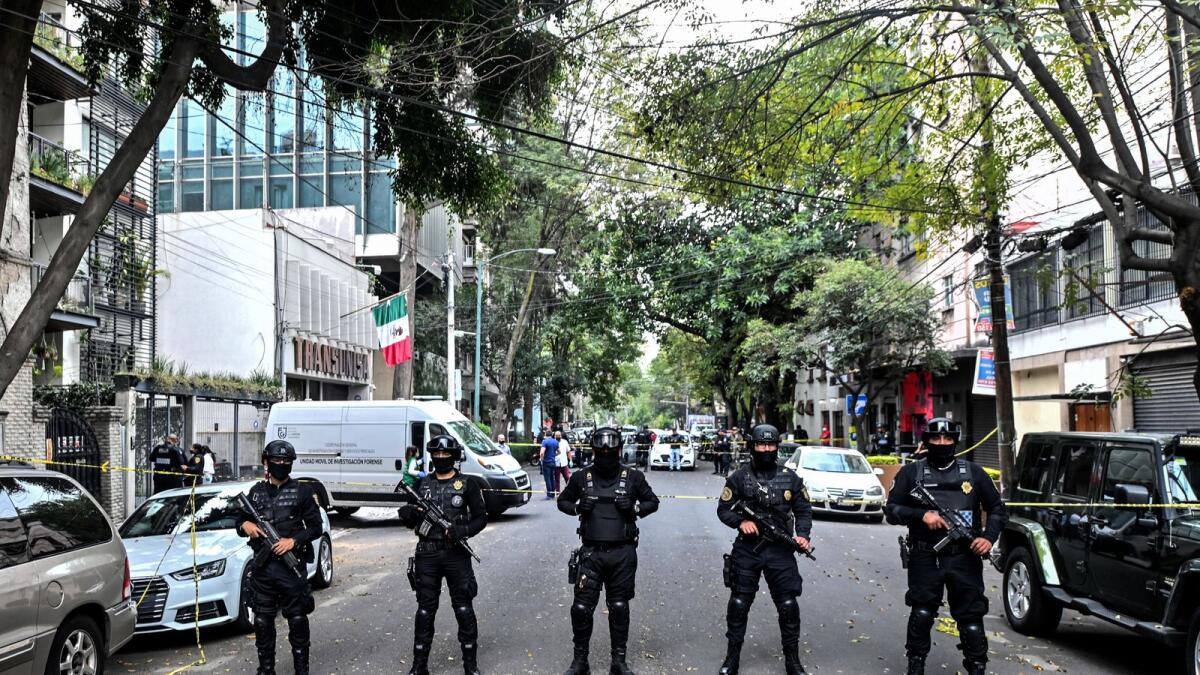 Mexican police officers stand in guard at the crime scene in this file photo.