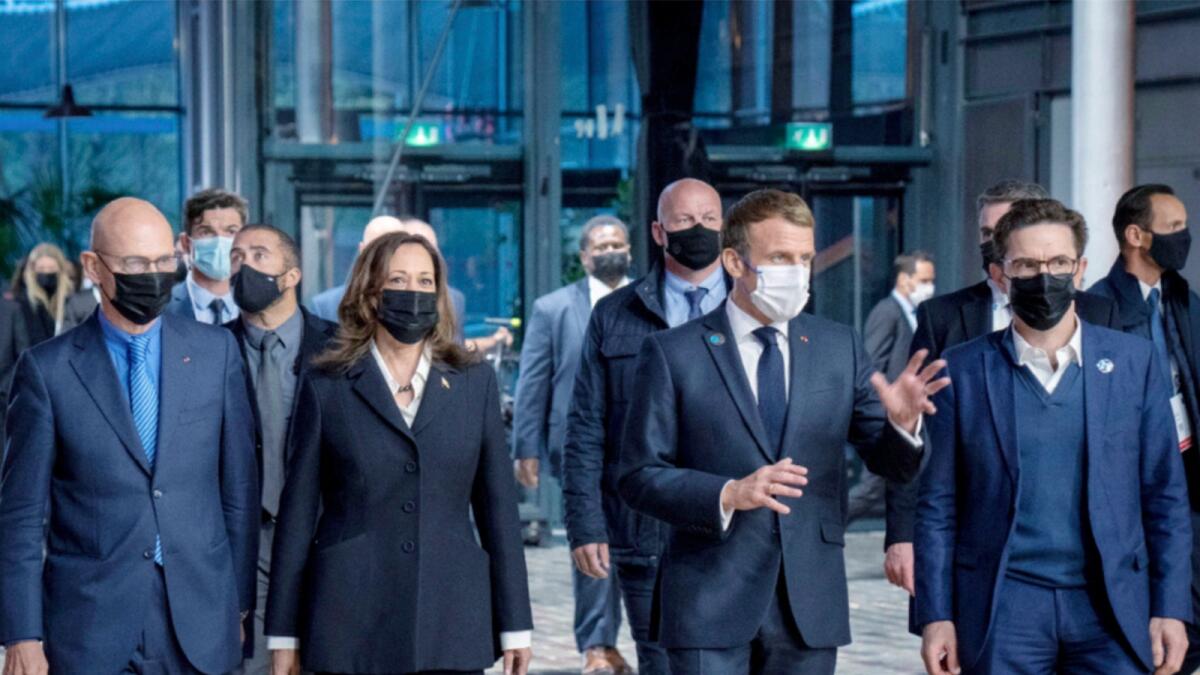 Former European Trade Commissioner Pascal Lamy, Kamala Harris, French President Emmanuel Macron and French historian Justin Vaïsse arrive at a Paris Peace Forum. — AP