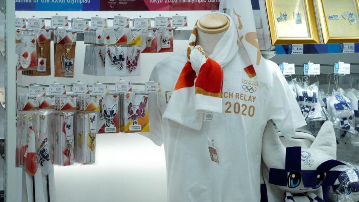 Official goods are displayed at a Tokyo Olympics 2020 souvenir shop in Tokyo on March 25, a day after the announcement of the games' postponement to 2021. (Reuters)