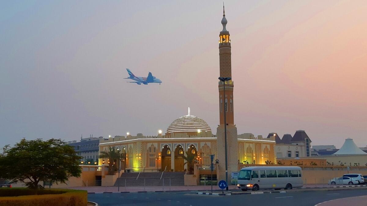 An Emirates plane flies over a mosque in Mirdif, Dubai. Photo: Juidin Bernarrd