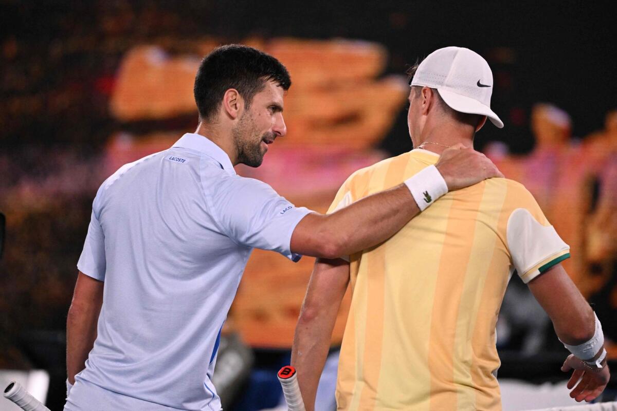 Novak Djokovic speaks to Dino Prizmic after beating him in the Australian Open. — AFP