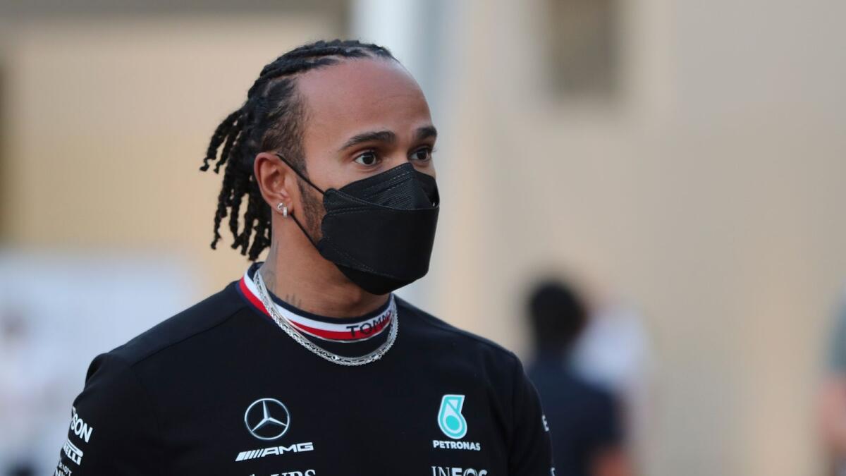 Mercedes driver Lewis Hamilton of Britain arrives at the Yas Marina racetrack in Abu Dhabi on Thursday. (AP)
