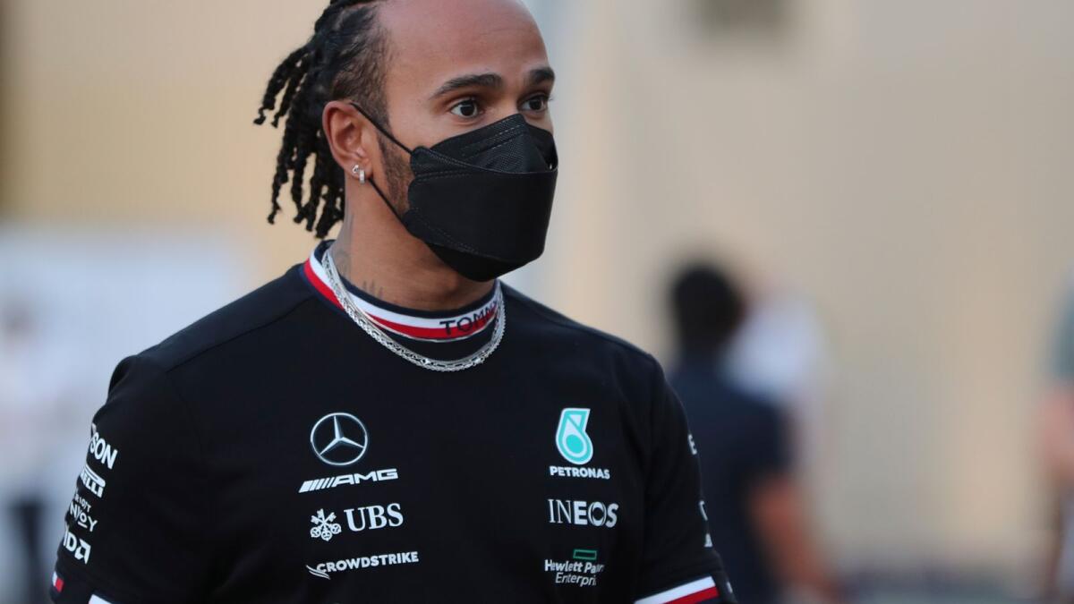 Mercedes driver Lewis Hamilton of Britain arrives at the Yas Marina racetrack in Abu Dhabi on Thursday. (AP)