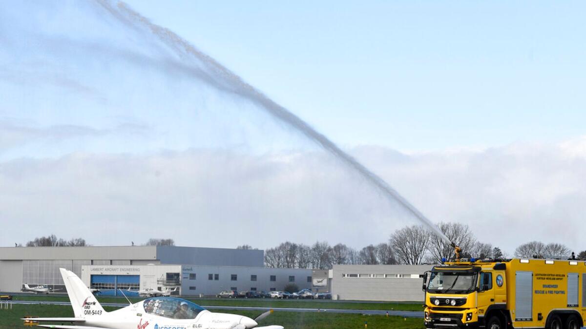 A firetruck sprays the plane of Belgium-British teenage pilot Zara Rutherford as she lands her plane at the Kortrijk airport in Belgium. – AP