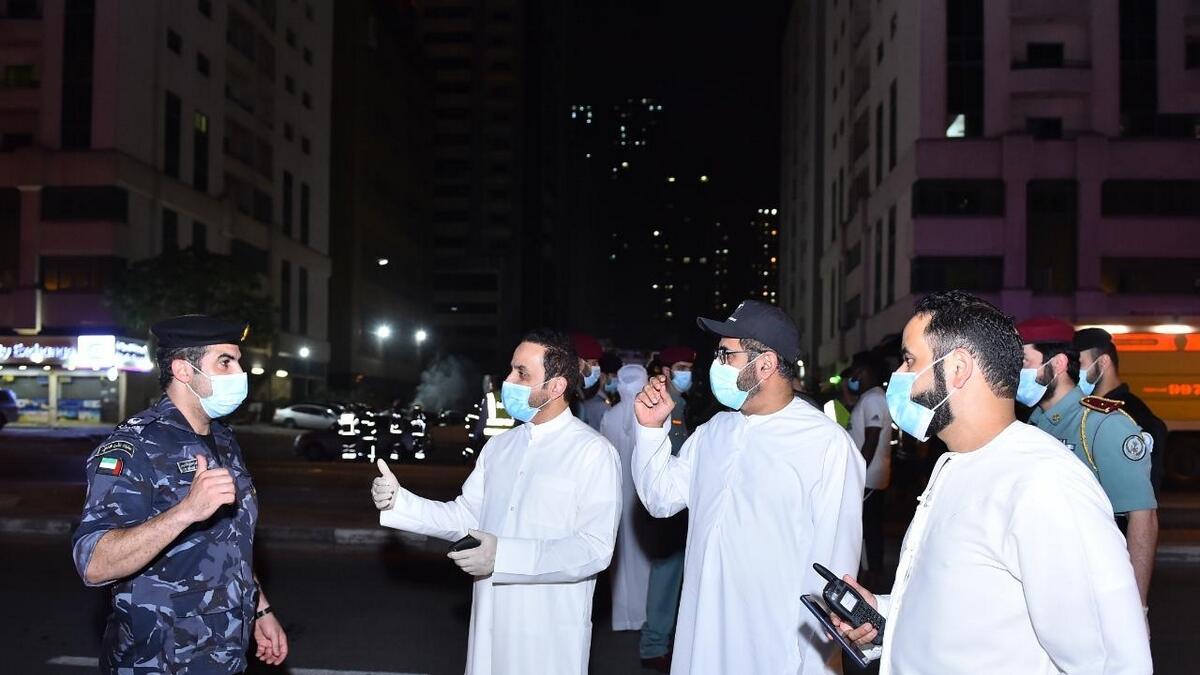 A Sharjah Civil Defence officer reassures tenants affected by the blaze.