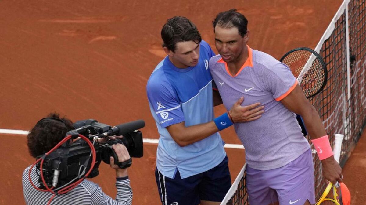 Spain's Rafael Nadal (R) greets Australia's Alex De Minaur after losing in the ATP Barcelona Open 'Conde de Godo' tennis tournament on Wednesday. - AFP