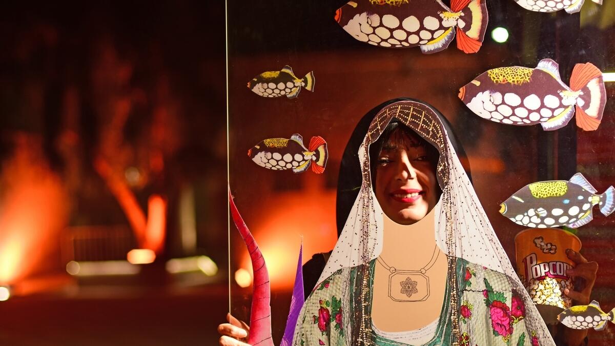 A woman looks through a mannequin dressed in traditional attire at the heritage site.