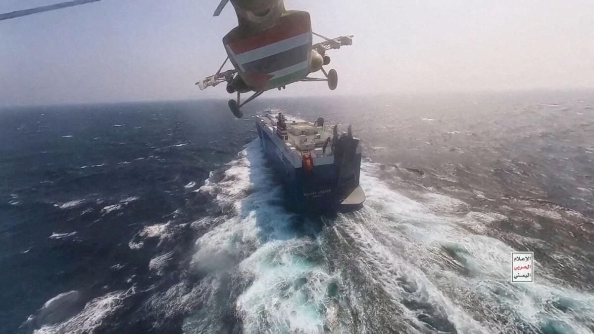 Houthi military helicopter flies over the Galaxy Leader cargo ship in the Red Sea in this photo released on November 20. — Reuters file