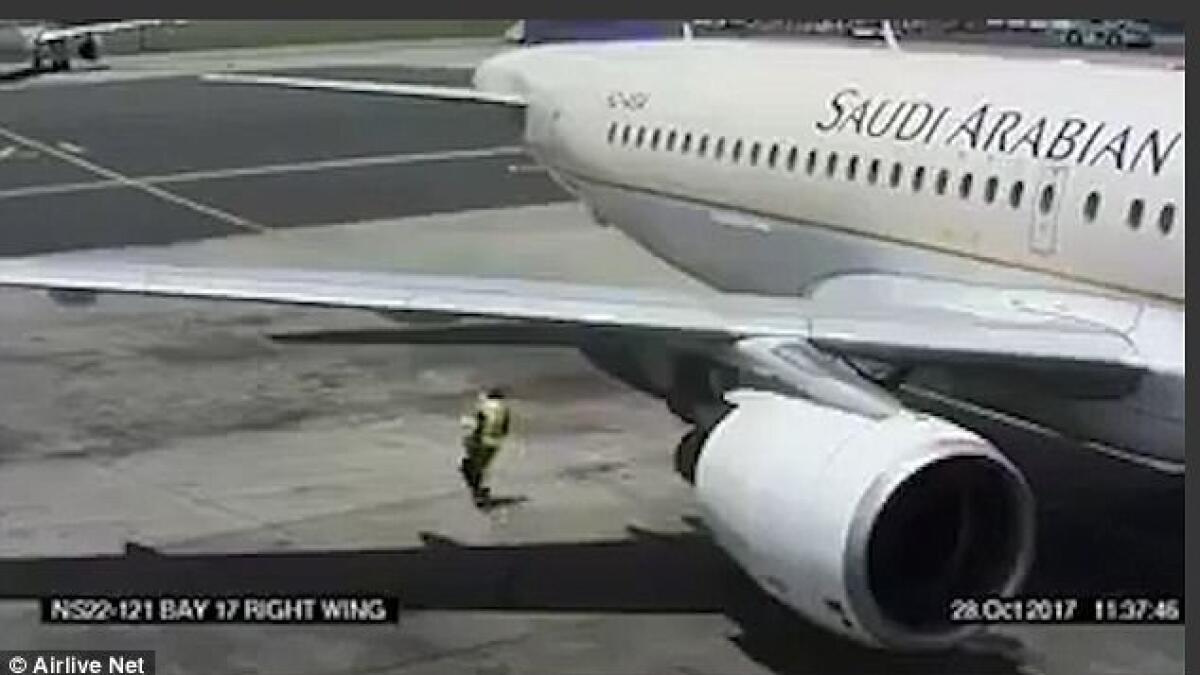 Video: Airport worker walks dangerously close to Saudi plane engine