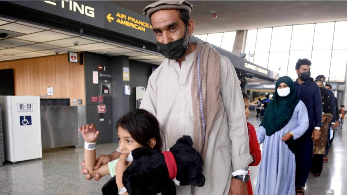 Afghan refugees arrive at Dulles International Airport. — AFP