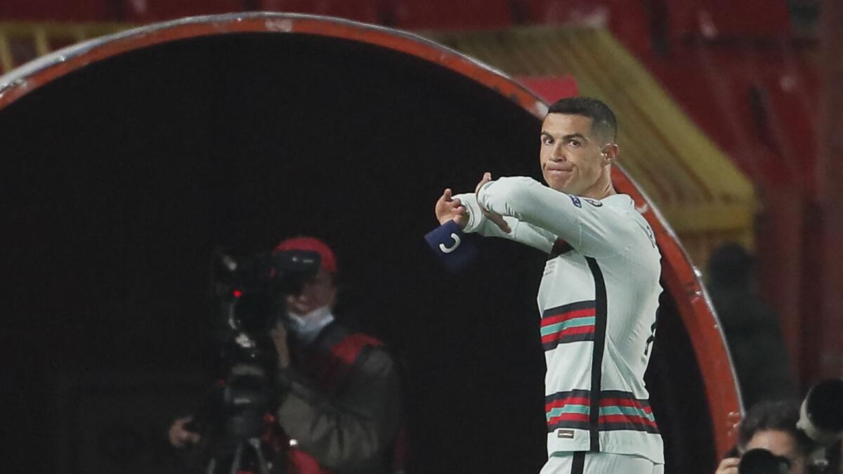 Cristiano Ronaldo holds his captain's armband moments before he threw it and left the pitch at the end of the Fifa World Cup qualification match against Serbia. (AFP)