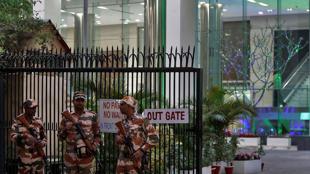 Members of the Indo-Tibetan Border Police stand guard outside a building housing BBC offices, where income tax officials are conducting a survey. — Reuters