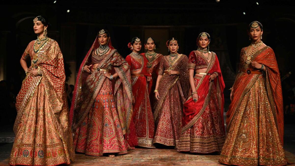 Models present creations by designer JJ Valaya during the FDCI India Couture Week in New Delhi on July 24, 2022.  (Photo by Sajjad HUSSAIN / AFP)