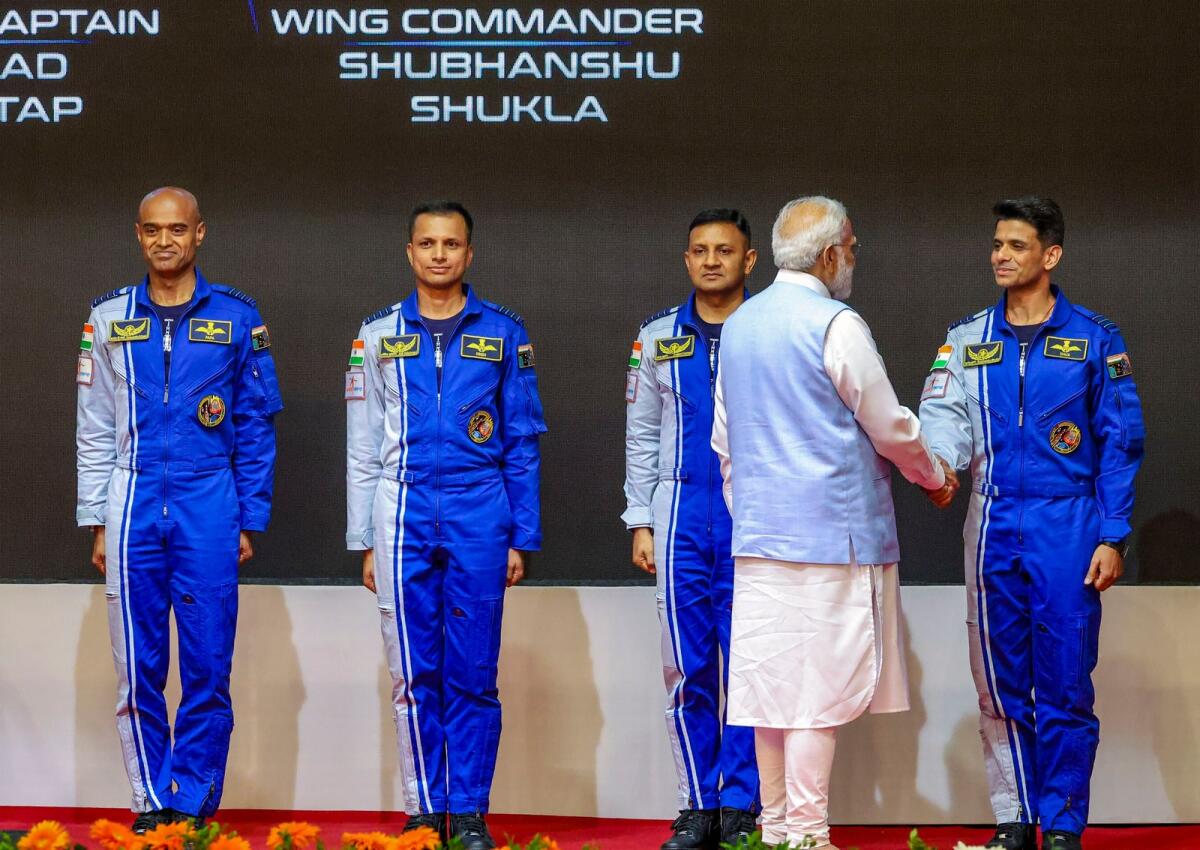 Prime Minister Narendra Modi hands-over wings to astronauts-designate, who have been selected to be the astronauts on India’s first crewed mission to space 'Gaganyaan Mission', at the Vikram Sarabhai Space Centre (VSSC). Photo: PTI