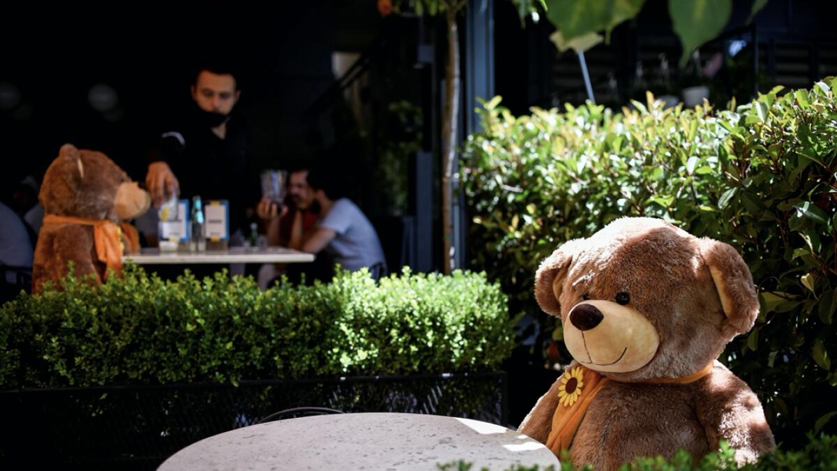 A large teddy bear, used to enforce social distancing, is pictured sitting at a cafe in Pristina, as Kosovo authorities announce new measures to fight against the resurgence of the Covid-19, the novel coronavirus. Photo: AFP